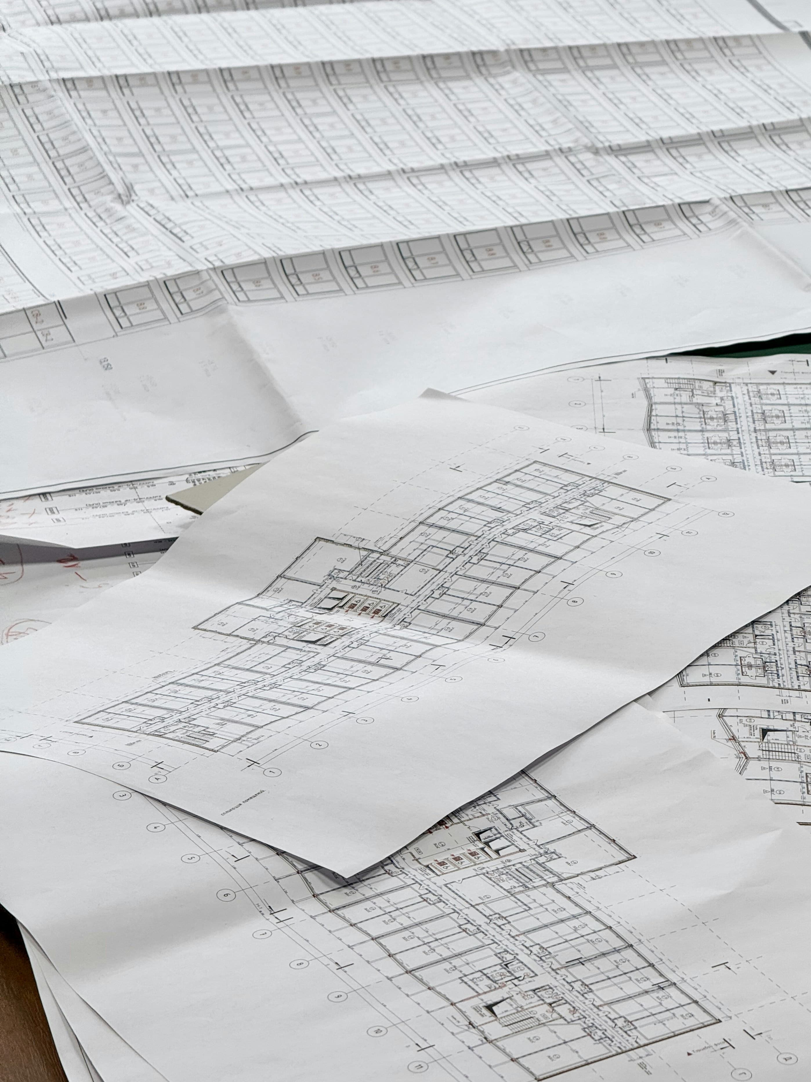 Construction drawings and floor plans spread across a table