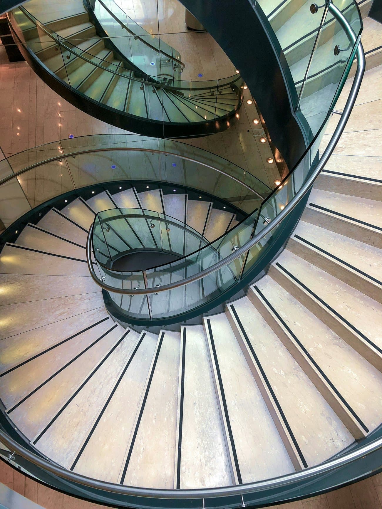 A sculptural glass and steel staircase, seen from above