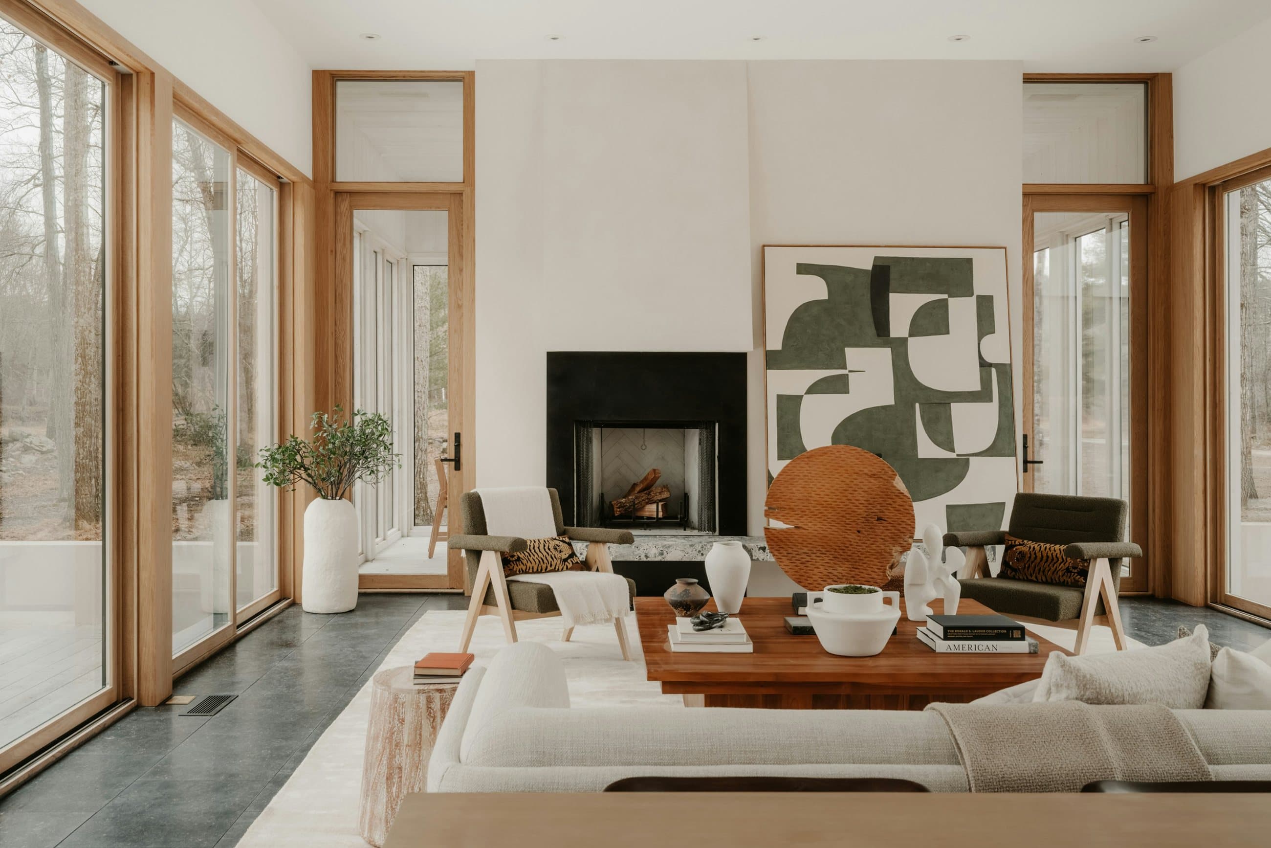 Stone and glass residence at dusk, with warm interior light